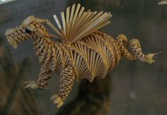 an origami horse on display in a glass case