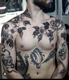 a shirtless man with tattoos on his chest