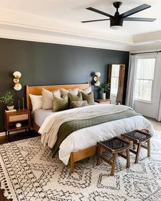 a bedroom with a large bed and ceiling fan in it's centerpieces