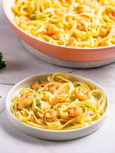 shrimp pasta in a bowl with parsley on the side