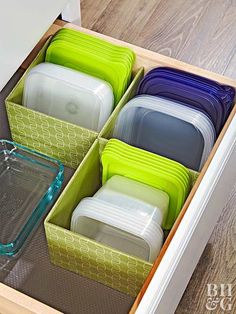 an open drawer filled with lots of dishes