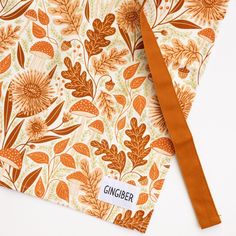 an orange and white floral pattern with the word ginger on it's front side