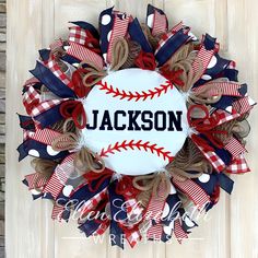 a baseball wreath with the name jackson on it and red, white, and blue ribbons