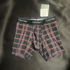 Calvin Klein Boxer Brief Small Charcoal Heather, Red, And Black Striped Design For A Plaid Pattern. Please Note: Due To The Natural Variance And Characteristic Of The Yarns/Fabrics, Slight Variations In Pattern May Occur New With Tags, Not Worn, Perfect Condition 95% Cotton 5% Spandex Limited Edition Holiday Styling. Full Rise. Waistband Sits At The Regular Level, Above Hip. Leg Line Sits Low On Thigh. Contoured Pouch For Support. Soft, Flexible Logo Waistband Retains Shape Wear After Wear. Casual Fitted Multi-pack Boxer Briefs, Fitted Cotton Boxer Briefs For Loungewear, Fitted Cotton Multi-pack Boxer Briefs, Fitted Casual Boxer Briefs Multi-pack, Fitted Casual Boxer Briefs, Casual Fitted Boxer Briefs, Red Fitted Cotton Boxer Briefs, Fitted Red Cotton Boxer Briefs, Calvin Klein Boxer Briefs