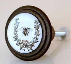 a close up of a knob with a bee on it