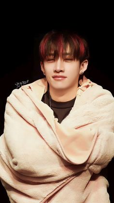 a man with red hair wrapped in a blanket