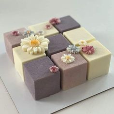 a square cake decorated with flowers and icing