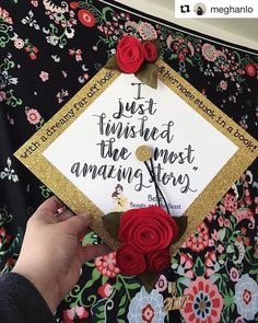 someone is holding up a graduation cap with flowers on it and the words just finished the most amazing story