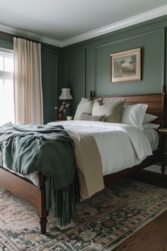 a large bed sitting next to a window in a room with green paint on the walls