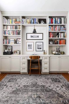 a home office with built in bookshelves and an area rug