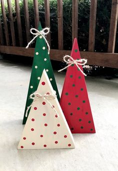 three wooden christmas trees with polka dots on them