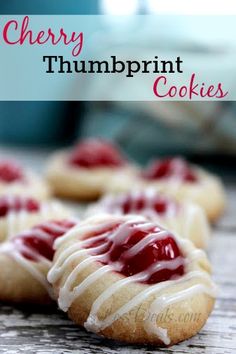 cherry thumbprint cookies with icing on a table