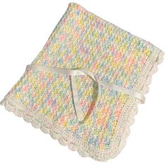 a crocheted blanket with a ribbon on it