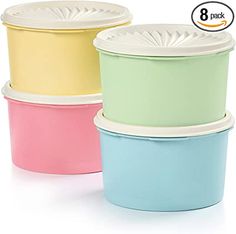 three different colored plastic containers with lids