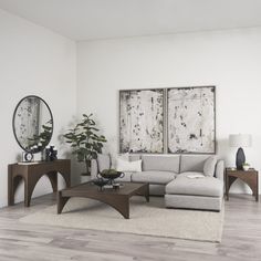 a living room filled with furniture and two mirrors