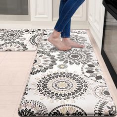 a woman standing on top of a rug in a kitchen