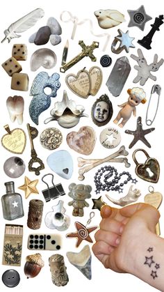 a person's hand pointing at an assortment of different items