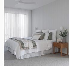 a bedroom with white walls and carpeted flooring