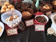 a table topped with lots of different types of food and desserts next to each other