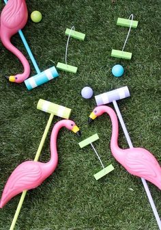 several flamingos and marshmallows on the grass