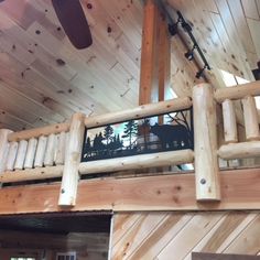 there is a wooden loft with stairs and railings