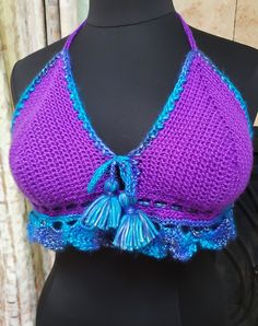 Yes! There is a bikini top for the large-breasted mermaid out there!! And it's right here. This super cute bikini has roomy cups and a tie laced through the bottom to contain your bounty. And the cute tassel tie and shell edging will have you grinning in delight. Size:  Large; cup DD and up Materials: Ice Picasso Turquoise, Blue Shades (44% acrylic, 56% polyester) Caron Simply Soft Purple (100% acrylic) Care Instructions: Machine washable and dryable - gentle cycle, low heat Purple Fitted Crop Top For Beach, Bohemian Purple Crop Top For Beach, Summer Purple Bra, Caron Simply Soft, Soft Purple, Cute Bikinis, Cropped Tube Top, Turquoise Blue, Womens Clothing Tops