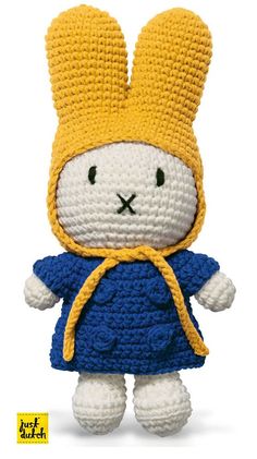 a crocheted stuffed animal wearing a blue dress and yellow hat with the words,