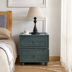 This nightstand brings a touch of farmhouse charm and transitional style to your bedroom. Crafted from kiln-dried solid paulownia wood, it features a stacked, rectangular shape with a finished back, ensuring it looks great from every angle. The two drawers glide smoothly on roller glides, offering easy access to your bedside essentials. Antique bronze ring handles add a vintage touch, complementing the rustic appeal of the paneled drawer fronts. With its versatile design, this nightstand can als Antique Bedside Tables, Transitional Nightstand, Bronze Handles, Bedside Essentials, Rustic Nightstand, Paulownia Wood, Primary Bedroom, Nursery Furniture Sets, Teen Bedding