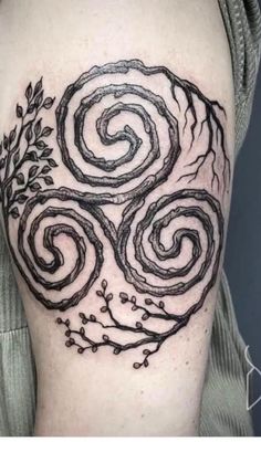 a black and white tattoo with swirls on it