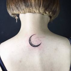 a woman with a crescent tattoo on her back