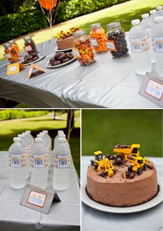 a table topped with a cake covered in chocolate frosting and construction themed decorations next to bottles of water