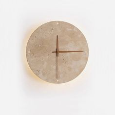 a clock made out of concrete on a white wall