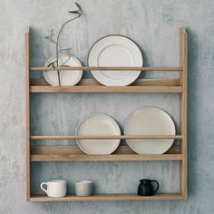 a shelf with plates and cups on it