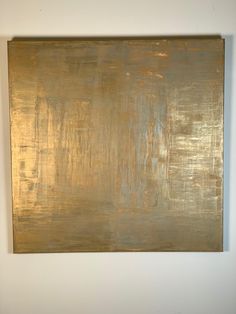 a large gold painting hanging on the wall