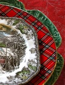 the plate is decorated with an image of a house and trees on it, along with other plates