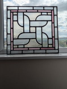 a stained glass window sitting on top of a window sill