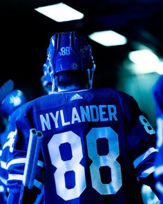 a hockey player is standing in the dark