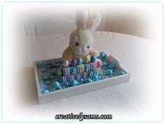 a stuffed rabbit sitting on top of a birthday cake