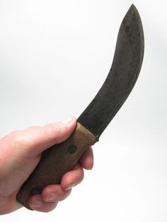 a person holding a knife in their hand with the handle extended to show it's blade