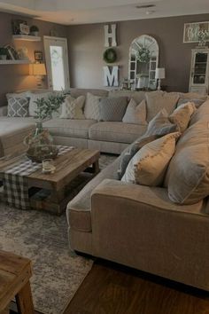 a living room with couches, tables and pictures hanging on the wall above them