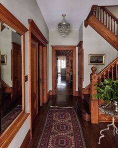 a hallway with wood floors and wooden handrails