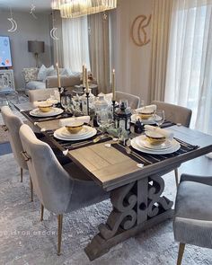 a dining room table set with place settings