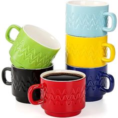 four different colored coffee mugs sitting next to each other