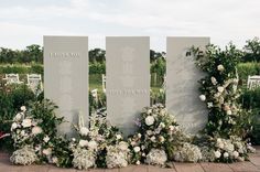 flowers and greenery are arranged around the names of those people who died