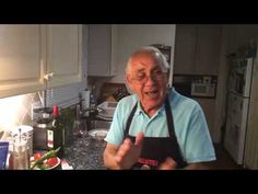 an older man in the kitchen making a funny face