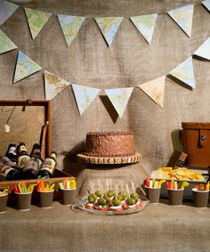 a table topped with a cake and lots of desserts next to other food items