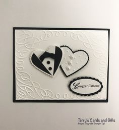 a white card with black and white paper on it, featuring two heart shaped buttons