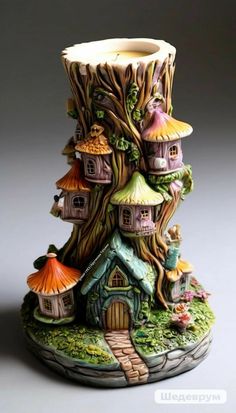 a ceramic vase with houses and trees on it