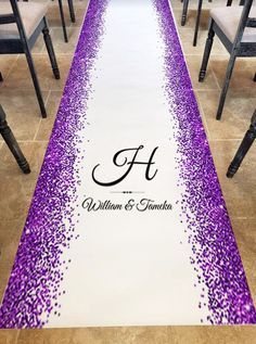 the aisle is decorated with purple and white confetti