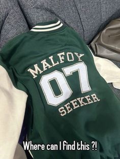 a green jacket with white letters on it and the words, where can i find this?